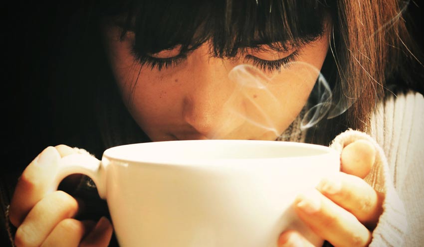 holding and drinking hot beverage in cold weather holding and drinking hot beverage